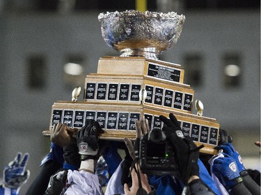 Players from the Montreal Carabins hoist the Vanier Cup after beating the McMaster Marauders in the CIS football final in Montreal Saturday, November 29, 2014.