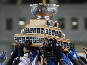 Université de Montréal Carabins players hoist the Vanier Cup after beating the McMaster Marauders at Molson Stadium on Saturday.