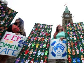 Women take part in a rally on Parliament Hill in Ottawa on Friday, October 4, 2013 by the Native Women's Association of Canada honouring the lives of missing and murdered Aboriginal women and girls.