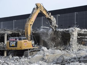 Work crews demolish the Mirabel Airport parking and terminal, Thursday, November 20, 2014 in Mirabel, Que. The Montreal airport authority is going ahead with demolition of the facility which has had no passenger flights since 2004.