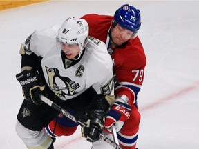 Canadiens defenceman Andrei Markov ties up Pittsburgh Penguins centre Sidney Crosby during NHL action at the Bell Centre on March 2, 2013.