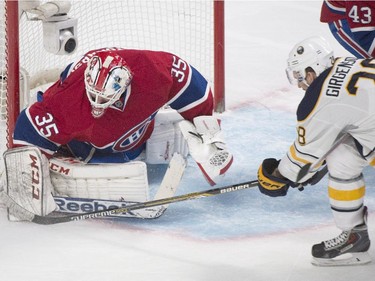 Buffalo Sabres' Zemgus Girgensons (28) moves in on Montreal Canadiens goaltender Dustin Tokarski during second period NHL hockey action in Montreal, Saturday, November 29, 2014.