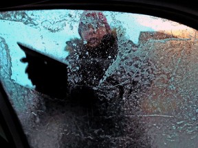 Freezing rain means flipping up your wipers and putting some elbow grease into scraping your windshield.
