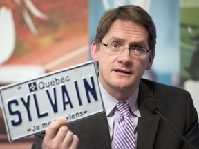 Former Quebec Transport Minister Sylvain Gaudreault announces the option to have personalized license plates, Thursday, Jan. 30, 2014, in Quebec City.
