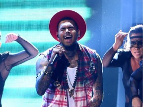 Recording artist Chris Brown seen here on stage during the 15th Annual Latin GRAMMY Awards has apologized for comments made about his ex girlfriend.