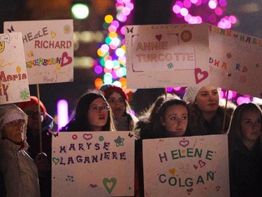 A group of Girl Guides hold signs with the victim's names to mark the 25th anniversary of the Polytechnique massacre Saturday, December 6, 2014 in London, Ont. It was 25 years ago today that a gunman shot and killed fourteen women before taking his own life at the École Poytechnique of the Université de Montréal.