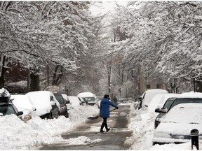 A motorist shovels out her car after the region received 30cm of snow in the first winter storm of the season Thursday, December 11, 2014 in Montreal.