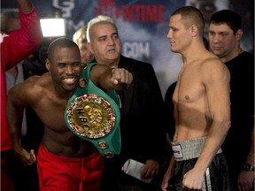 WBC light heavyweight champion Adonis Stevenson, left, reacts while facing Dmitriy Sukhotskiy at the weigh-in, Dec. 18, 2014 in Quebec City. Stevenson will defend his WBC light heavyweight title against Sukhotskiy on Friday Dec. 19 at the Quebec Colisee.