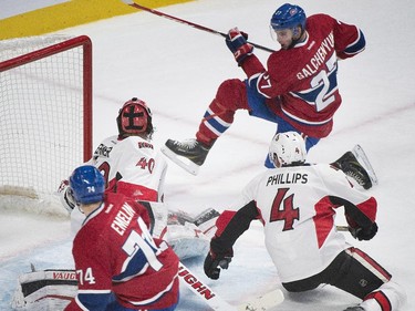 Montreal Canadiens' Alex Galchenyuk scores against Ottawa Senators goaltender Robin Lehner  as Canadiens' Alexei Emelin and Senators' Chris Phillips look for the rebound during third period NHL hockey action in Montreal, Saturday, December 20, 2014.