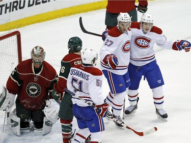 Montreal Canadiens centre Alex Galchenyuk (27) is congratulated by teammates  Brendan Gallagher, right, and David Desharnais (51) after scoring on Minnesota Wild goalie Darcy Kuemper, left, during the third period of an NHL hockey game in St. Paul, Minn., Wednesday, Dec. 3, 2014. The Wild won 2-1.