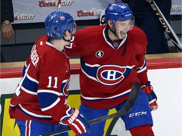 Montreal Canadiens centre Alex Galchenyuk , right, celebrates with teammate Brendan Gallagher after scoring a hat trick to defeat the Carolina Hurricanes 4-1 in National Hockey League action Tuesday, December 16, 2014 in Montreal.