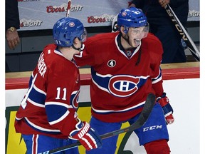 Montreal Canadiens center Alex Galchenyuk , right, celebrates with teammate Brendan Gallagher after scoring a hat trick to defeat the Carolina Hurricanes 4-1 in National Hockey League action Tuesday, December 16, 2014 in Montreal.THE CANADIAN PRESS/Ryan Remiorz