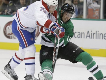 Montreal Canadiens defenceman Alexei Emelin (74) and Dallas Stars left wing Ryan Garbutt (16) vie for control of the puck during the first period of an NHL hockey game Saturday, Dec. 6, 2014, in Dallas.