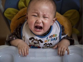 A young Chinese cries as she waits for feeding at a foster care centre on April 2, 2014 in Beijing, China. China's orphanages and foster homes used to be filled with healthy girls, reflecting the country's one-child policy and its preference for sons. Now the vast majority of orphans are sick or disabled. China says it has 576,000 orphans in its child welfare system though outside groups put the number at closer to a million. The parents who abandon them either cannot afford treatment or feel an inability to cope with raising a child who has special needs. In many cases an unwanted baby is never registered so the parents can skirt the one-child policy if they try for another.