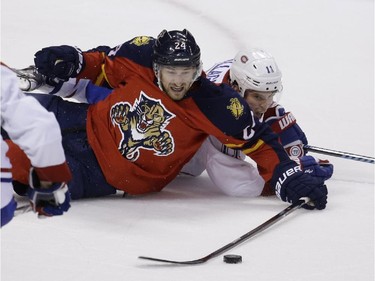 Florida Panthers right wing Brad Boyes (24) and Montreal Canadiens right wing Brendan Gallagher (11) scramble for the puck during the third period of an NHL hockey game, Tuesday, Dec. 30, 2014, in Sunrise, Fla. The Canadiens won 2-1 in a shootout.