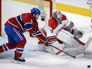Montreal Canadiens right wing Brandon Prust (8) is stopped by Carolina Hurricanes goalie Cam Ward (30) during second period National Hockey League action Tuesday, December 16, 2014 in Montreal.