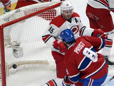 Montreal Canadiens right wing Brandon Prust (8) scores the first goal as Carolina Hurricanes defenceman Ron Hainsey (65) tries to guard the open net during first period National Hockey League action Tuesday, December 16, 2014 in Montreal.