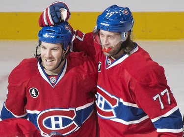 Montreal Canadiens' Brandon Prust celebrates with teammates Tom Gilbert and Nathan Beaulieu after scoring against the Ottawa Senators during first period NHL hockey action in Montreal, Saturday, December 20, 2014.