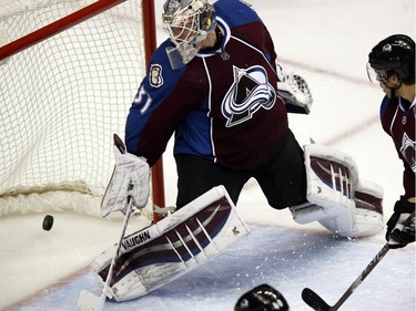 Colorado Avalanche goalie Calvin Pickard watches as a power-play goal slips into the net off stick of Montreal Canadiens defenceman Andrei Markov in the second period of an NHL hockey game in Denver on Monday, Dec. 1, 2014.