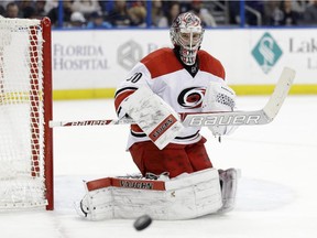 Carolina Hurricanes goalie Cam Ward makes a save on shot by the Tampa Bay Lightning during NHL game on Dec. 27, 2014, in Tampa, Fla.