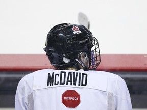 Connor McDavid sits on the bench during Team Canada junior practice at the Meridian Centre on Dec. 15, 2014 in St Catharines, Ont.