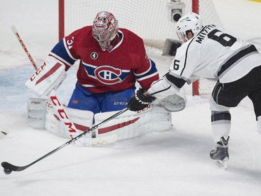 Los Angeles Kings' Jake Muzzin moves in on Montreal Canadiens goaltender Carey Price during first period NHL hockey action in Montreal, Friday, December 12, 2014.