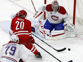 Montreal Canadiens goalie Carey Price (31) blocks the shot of a charging Carolina Hurricanes' Riley Nash (20) during the third period of an NHL hockey game in Raleigh, N.C., Monday, Dec. 29, 2014. Montreal won 3-1.