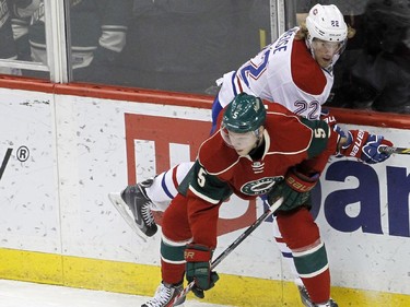Minnesota Wild defenceman Christian Folin (5) and Montreal Canadiens right wing Dale Weise (22) battle for the puck during the first period of an NHL hockey game in St. Paul, Minn., Wednesday, Dec. 3, 2014.