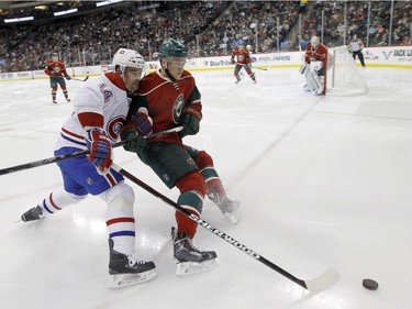 Minnesota Wild defenceman Christian Folin, right, and Montreal Canadiens centre Tomas Plekanec, left, of the Czech Republic, chase the puck during the second period of an NHL hockey game in St. Paul, Minn., Wednesday, Dec. 3, 2014. The Wild won 2-1.