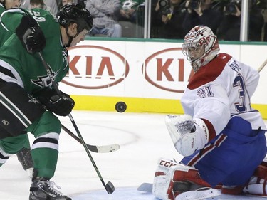 Dallas Stars centre Cody Eakin (20) scores a goal against Montreal Canadiens goalie Carey Price (31) during the first period of an NHL hockey game Saturday, Dec. 6, 2014, in Dallas.