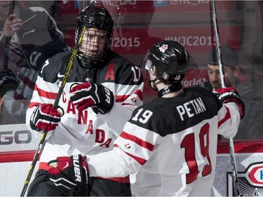 Team Canada's Connor McDavid, left, celebrates his goal against Team Germany with teammate Nic Petan during first period preliminary round hockey action at the IIHF World Junior Championship Saturday, December 27, 2014 in Montreal.