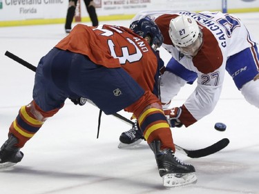 Florida Panthers center Dave Bolland (63) and Montreal Canadiens center Alex Galchenyuk (27) go for the puck in a face-off during the first period of an NHL hockey game, Tuesday, Dec. 30, 2014, in Sunrise, Fla.