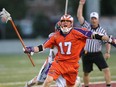 Brodie Merrill of the Hamilton Nationals takes a slash against the Denver Outlaws in a Major League Lacrosse game on July 28, 2012 at Ron Joyce Stadium in Hamilton.
