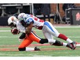 MONTREAL, QC - NOVEMBER 16:  Kyries Hebert #34 of the Montreal Alouettes sacks Kevin Glenn #2 of the BC Lions during the CFL Eastern Division Semi-Final game at Percival Molson Stadium on November 16, 2014 in Montreal, Quebec, Canada.  The Alouettes defeated the Lions 51-17.
