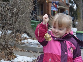 Jillian Juhl displays a handmade bird feeder Dec. 26, 2014.