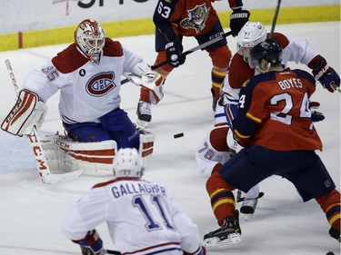 Montreal Canadiens goalie Dustin Tokarski (35) deflects the puck as Florida Panthers right wing Brad Boyes (24) watches during the third period of an NHL hockey game, Tuesday, Dec. 30, 2014, in Sunrise, Fla. The Canadiens defeated the Panthers 2-1 in a shootout.