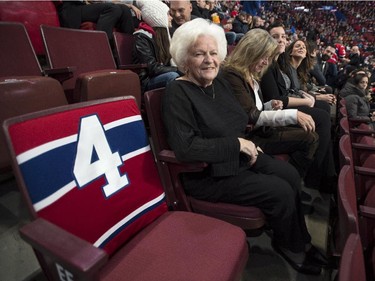 Elise Beliveau sits next to her husband Montreal Canadiens legend Jean Beliveau's empty seat, prior to a ceremony Tuesday, December 9, 2014 in Montreal. Beliveau died last week at the age of 83.