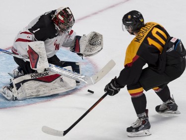 Team Canada goaltender Eric Comrie makes the save off Team Germany's Marc Michaelis during second period preliminary round hockey action at the IIHF World Junior Championship Saturday, December 27, 2014 in Montreal.