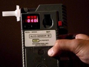 An RCMP constable holds a breathalyzer test in Surrey, B.C.