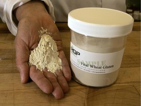 In this Monday, April 30, 2007 file photo, application technologist Jennifer Gaul holds a handful of wheat gluten at MGP Ingredients Inc. in Atchison, Kan.