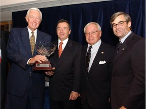 Canadiens great Jean Béliveau is photographed in 2003 with the new Jean Béliveau Trophy, created for annual awarding to the Canadiens player who best exemplifies leadership qualities in the community. From left, with their 2003 positions: Jean Béliveau; Dan O'Neill of Molson Inc.; Canadiens majority owner George N. Gillett Jr.; Canadiens president Pierre Boivin.