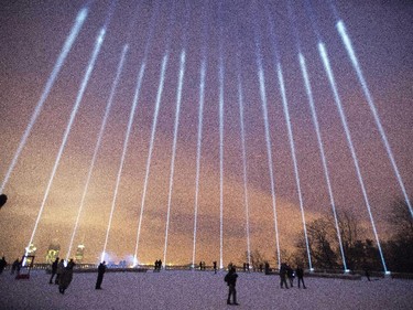 Fourteen lights shine toward the sky during a ceremony on Mount Royal to mark the 25th anniversary of the Polytechnique massacre Saturday, December 6, 2014 in Montreal. It was 25 years ago today that a gunman shot and killed 14 women before taking his own life at the École Poytechnique of the Université de Montréal.