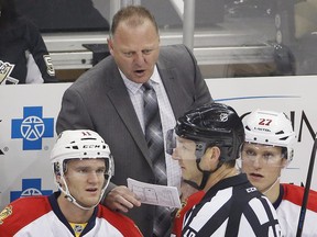 Florida Panthers head coach Gerard Gallant talks with referee Steve Kozari during game against the Penguins in Pittsburgh on Dec. 20, 2014.