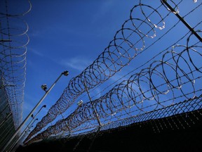 Razor wire around a prison complex.