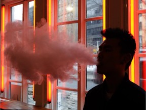 A patron exhales vapour from an e-cigarette.