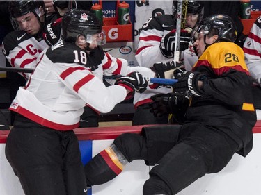 Team Germany's Andreas Eder is stopped by Team Canada's Jake Virtanen during second period preliminary round hockey action at the IIHF World Junior Championship Saturday, December 27, 2014 in Montreal.