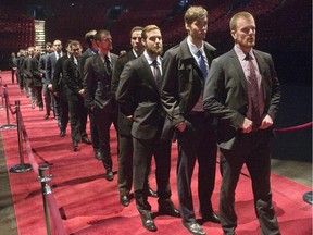 Members of the Vancouver Canucks line up to pay their respects to Jean Béliveau during visitation at the Bell Centre on Dec. 8, 2014.