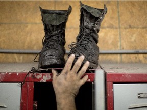 A miner reaches for his boots.