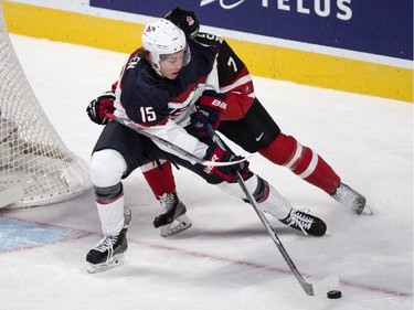 USA's John Hayden stretches out to break away from Canada's defenceman Josh Morrissey during first period preliminary round hockey action at the IIHF World Junior Championship, Wednesday, December 31, 2014 in Montreal.