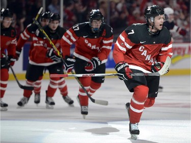 Canada's Josh Morrissey, right, celebrates after scoring the second goal against the USA during second period preliminary round hockey action at the IIHF World Junior Championship Wednesday, December 31, 2014 in Montreal.
